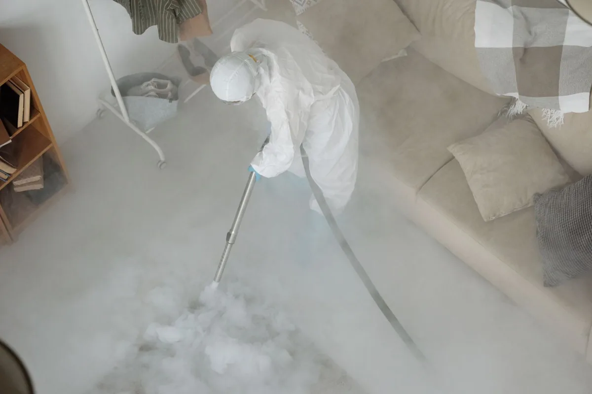 Biohazard cleanup technician in protective equipment, Downtown, Houston, TX